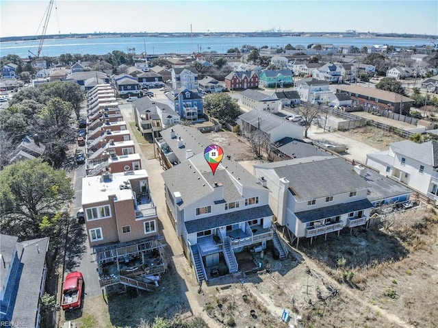 drone / aerial view with a residential view and a water view