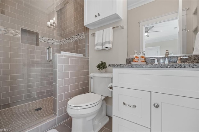 bathroom featuring vanity, ornamental molding, a shower stall, and toilet