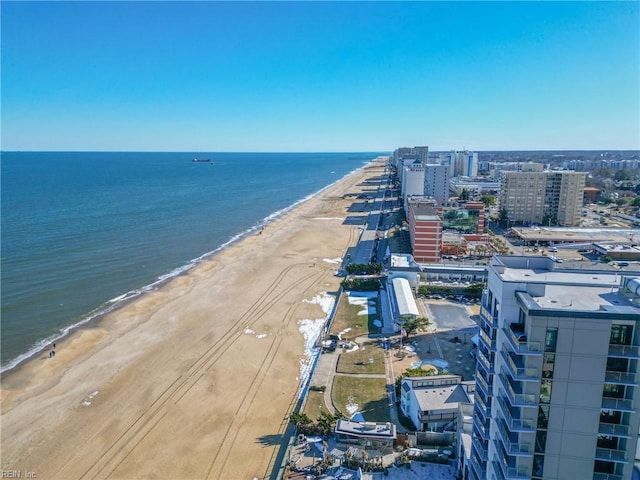 aerial view featuring a view of the beach, a water view, and a view of city