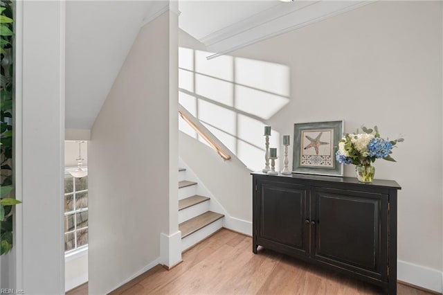 stairway with baseboards and wood finished floors