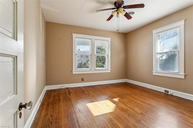 empty room with hardwood / wood-style flooring, ceiling fan, baseboards, and a wealth of natural light