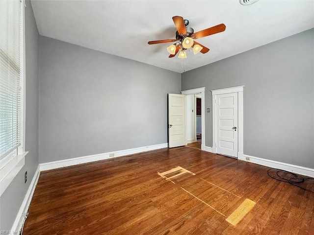 unfurnished bedroom featuring a ceiling fan, baseboards, and wood finished floors