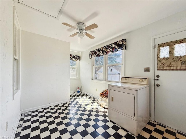 clothes washing area with light floors, attic access, washer / dryer, laundry area, and baseboards