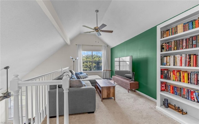 sitting room featuring built in shelves, carpet flooring, vaulted ceiling, ceiling fan, and baseboards