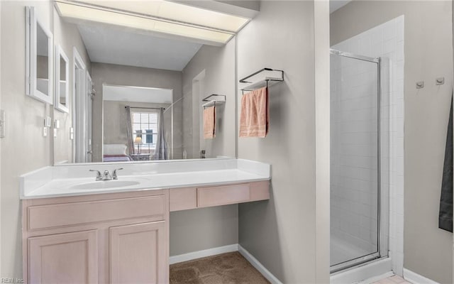 ensuite bathroom with ensuite bath, a shower stall, and baseboards