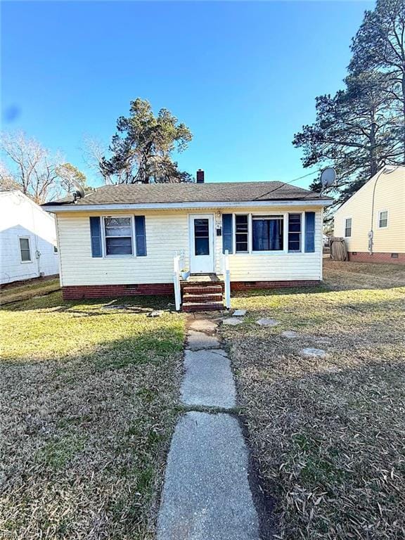 view of front of property featuring crawl space, a chimney, and a front yard