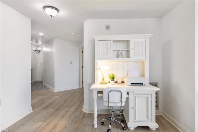 office area with baseboards, visible vents, and light wood-style floors