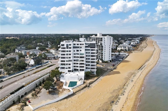 drone / aerial view featuring a water view and a beach view