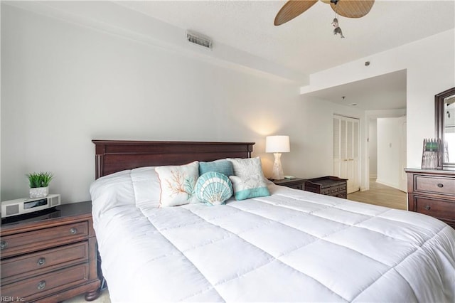 bedroom featuring visible vents, ceiling fan, and light wood finished floors