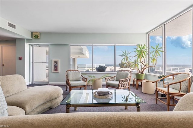 carpeted living area with visible vents and baseboards