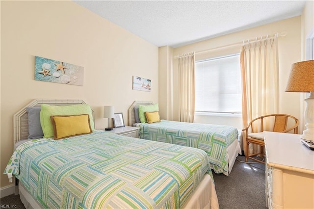 bedroom with baseboards and a textured ceiling