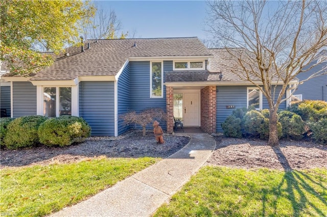 view of front of property with a shingled roof