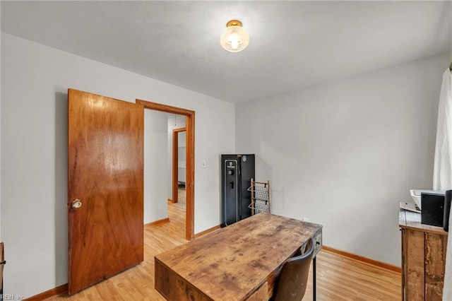 office area featuring light wood finished floors and baseboards