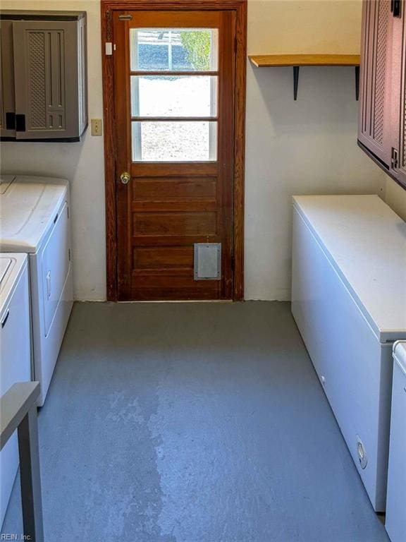 laundry room featuring cabinet space and separate washer and dryer