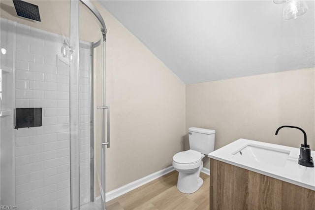 full bath featuring a stall shower, baseboards, toilet, wood finished floors, and vaulted ceiling