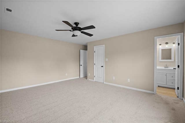 unfurnished bedroom with baseboards, visible vents, and light colored carpet