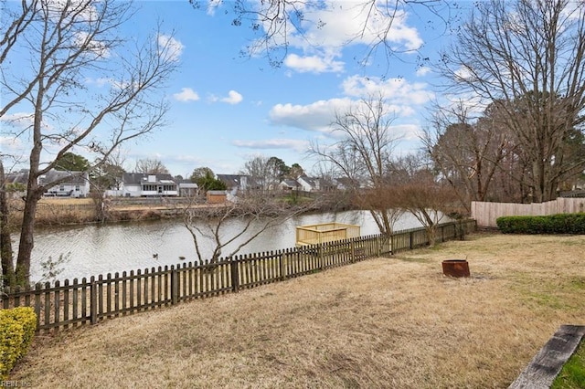 view of yard with a water view and fence