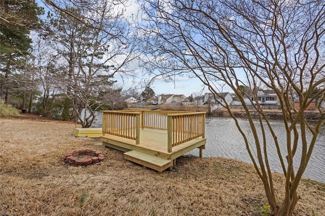 deck featuring a residential view, a water view, and a fire pit