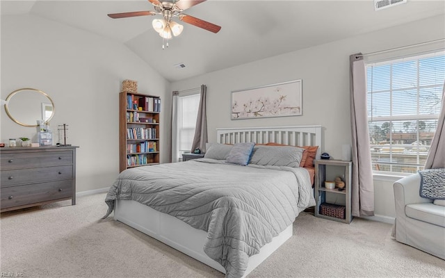 carpeted bedroom featuring lofted ceiling, visible vents, ceiling fan, and baseboards