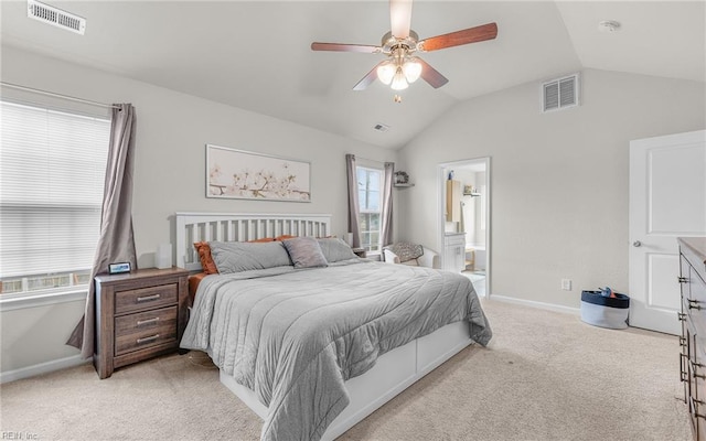 bedroom featuring vaulted ceiling, visible vents, and light colored carpet