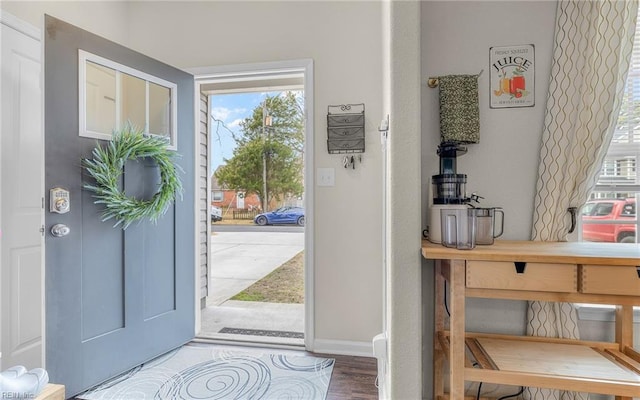 entrance foyer with wood finished floors and baseboards