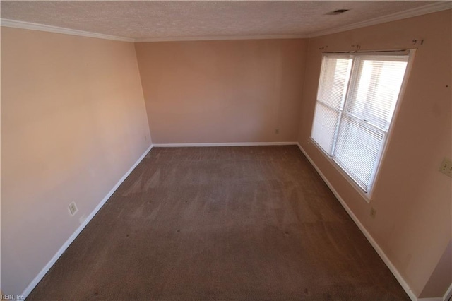 spare room featuring carpet floors, visible vents, ornamental molding, a textured ceiling, and baseboards