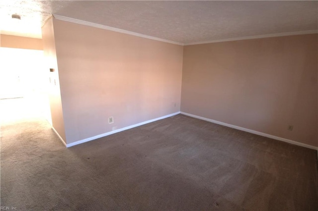 empty room with baseboards, dark colored carpet, and ornamental molding