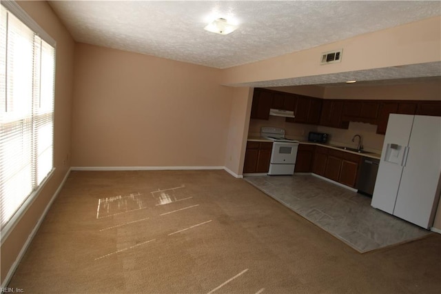 kitchen with visible vents, a sink, a textured ceiling, white appliances, and under cabinet range hood