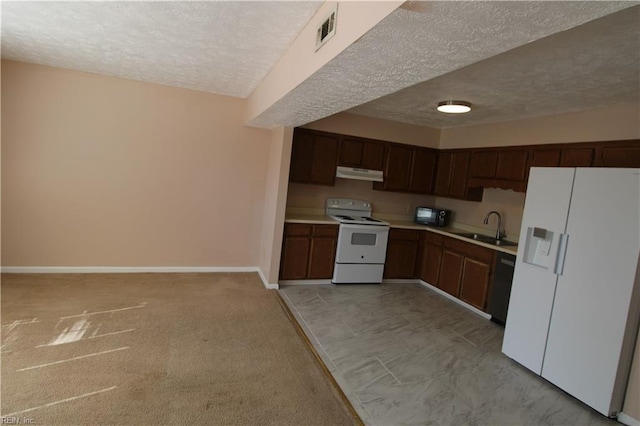 kitchen with light countertops, visible vents, a sink, white appliances, and under cabinet range hood