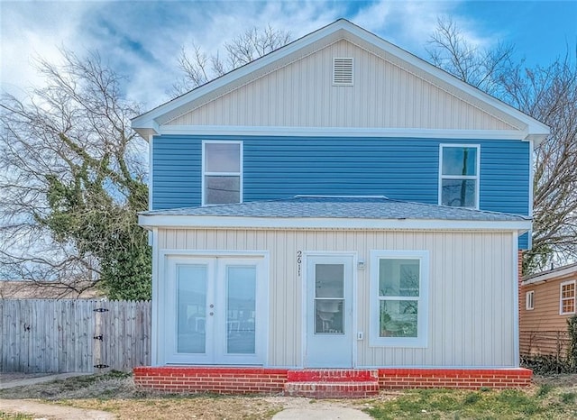 view of front of home featuring fence, a shingled roof, and entry steps