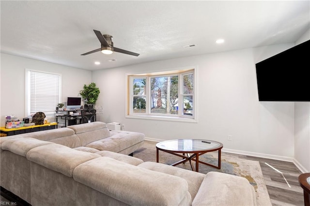 living room featuring recessed lighting, wood finished floors, a ceiling fan, visible vents, and baseboards