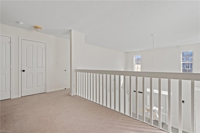 hallway with carpet floors