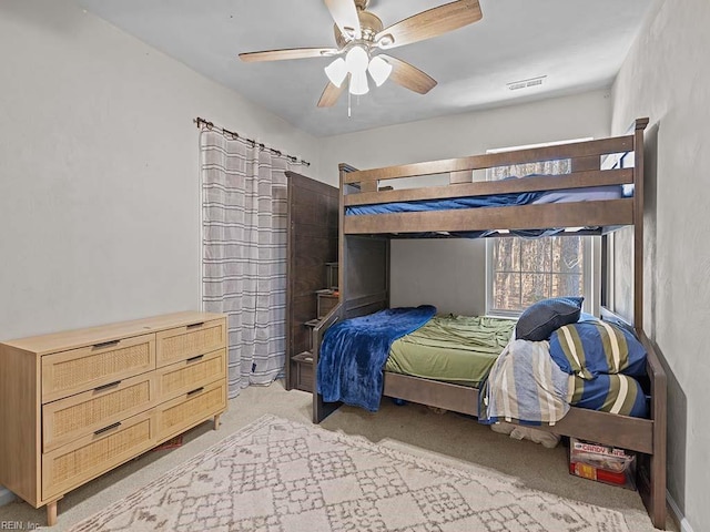 bedroom featuring a ceiling fan, light carpet, and visible vents