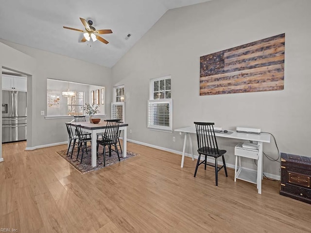 dining area with light wood-type flooring, visible vents, baseboards, and ceiling fan with notable chandelier