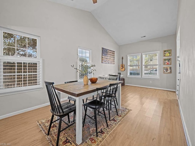 dining area featuring a healthy amount of sunlight, light wood-style floors, ceiling fan, and baseboards