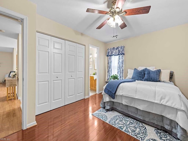 bedroom with ceiling fan, a closet, baseboards, and wood finished floors