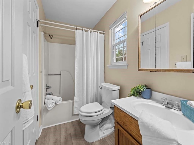 bathroom with wood finished floors, vanity, toilet, and shower / bathtub combination with curtain