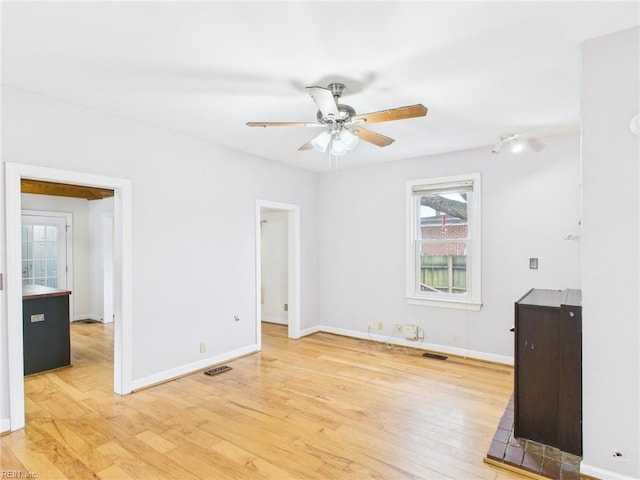 unfurnished living room featuring light wood-style flooring, visible vents, baseboards, and ceiling fan