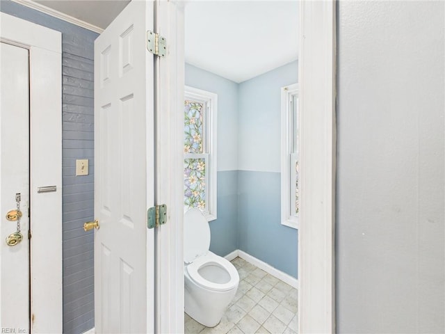 bathroom with toilet and baseboards