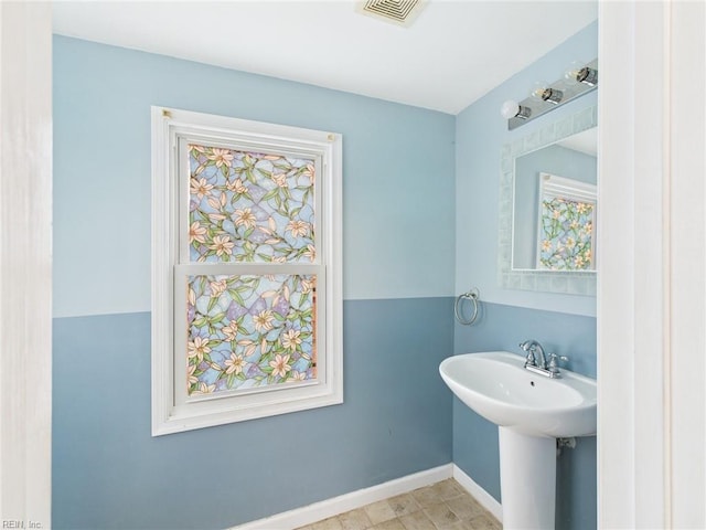 bathroom featuring baseboards and visible vents