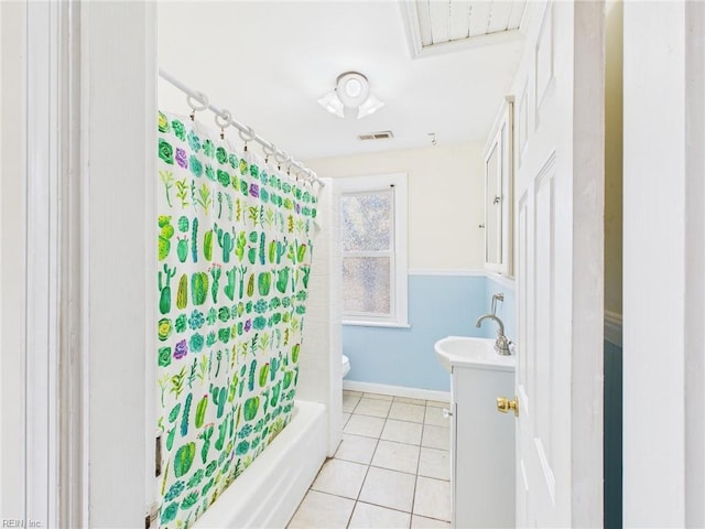 bathroom with toilet, vanity, visible vents, tile patterned floors, and shower / bath combo