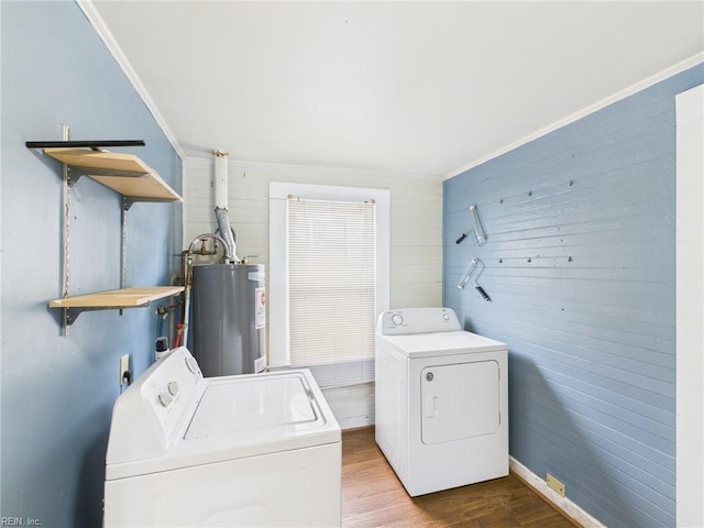 laundry area with laundry area, wood finished floors, crown molding, washing machine and dryer, and water heater