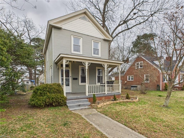 victorian home with covered porch and a front lawn