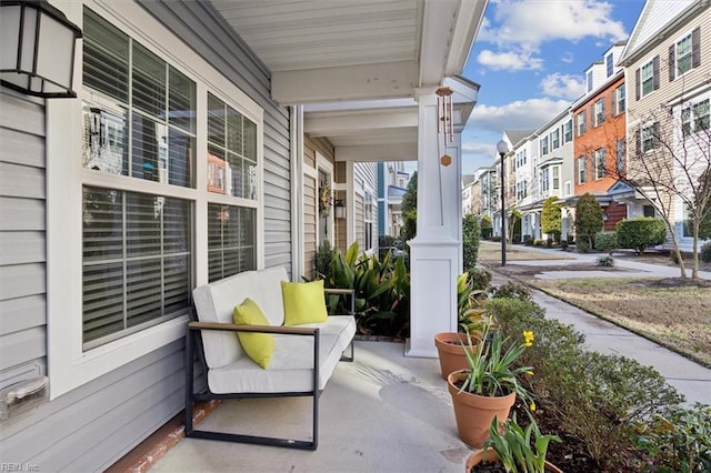 view of patio / terrace featuring a porch and a residential view