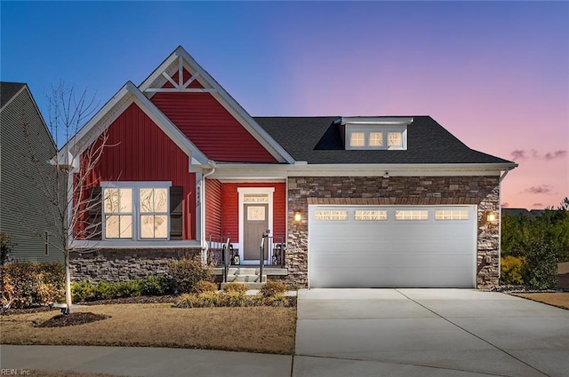 craftsman inspired home featuring stone siding, driveway, an attached garage, and board and batten siding