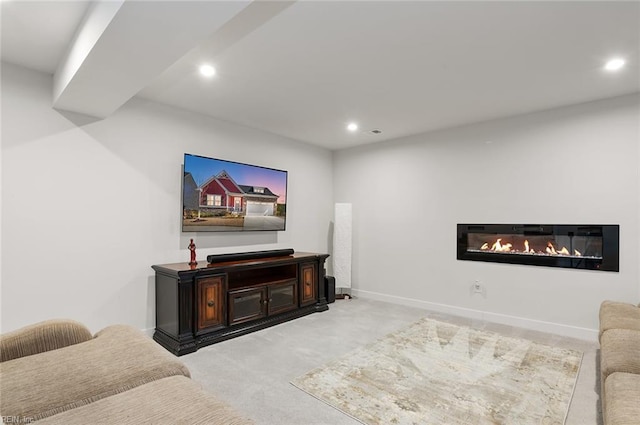 living area featuring recessed lighting, baseboards, light colored carpet, and a glass covered fireplace