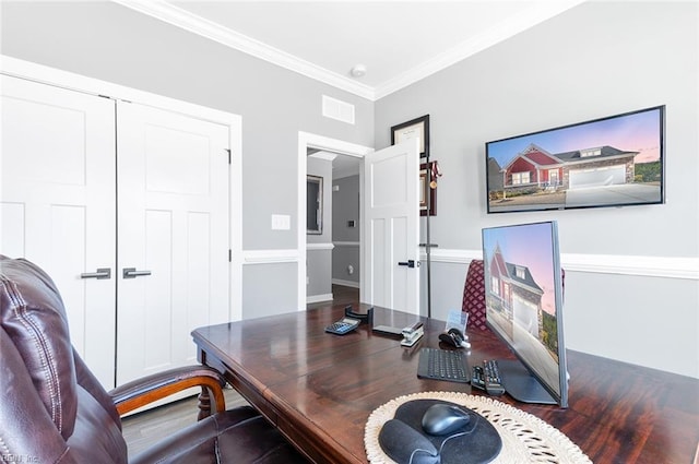 office area featuring wood finished floors, visible vents, and ornamental molding