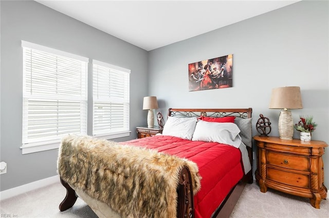 carpeted bedroom featuring baseboards