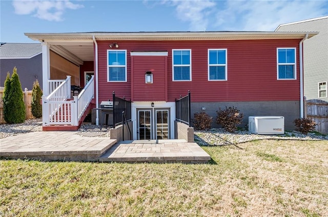 back of property featuring a patio, a lawn, brick siding, and fence