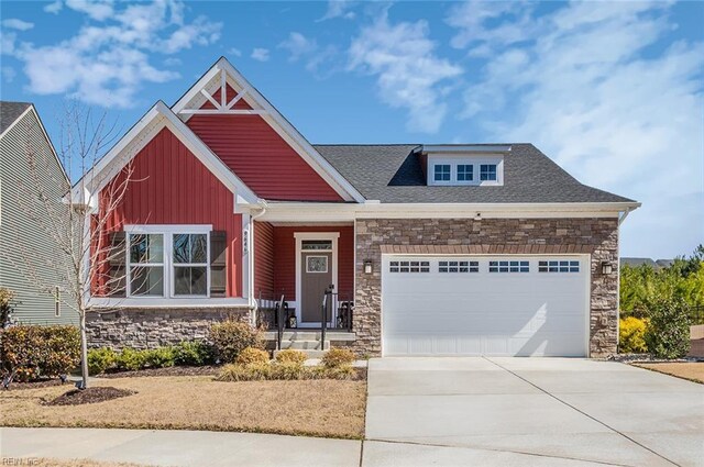 craftsman inspired home with stone siding, board and batten siding, concrete driveway, an attached garage, and a shingled roof